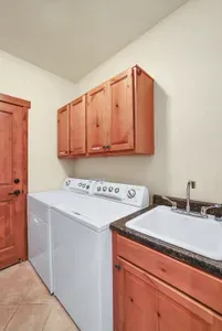 Discover the convenience of a spacious laundry room, complete with a full-sized washer, dryer, and utility sink, ensuring all your laundry needs are met effortlessly during your stay
