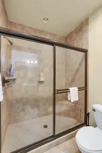 Indulge in the luxury of a spacious walk-in shower, designed to offer both relaxation and rejuvenation with its sleek fixtures and ample room.