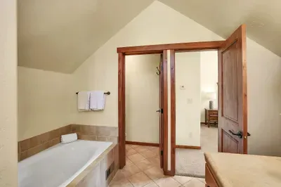 Spa-like Serenity: The ensuite bathroom is a haven of relaxation, featuring a spacious soaker tub and a luxurious walk-in shower, designed to offer you a spa experience right at home