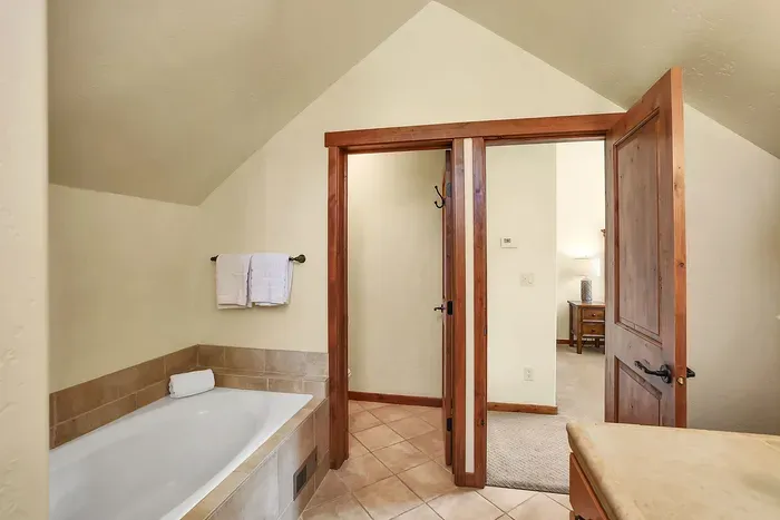 Spa-like Serenity: The ensuite bathroom is a haven of relaxation, featuring a spacious soaker tub and a luxurious walk-in shower, designed to offer you a spa experience right at home