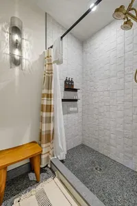 Morning rush? No problem—this bathroom was built for groups. Additional mirrored shower just across the bathroom