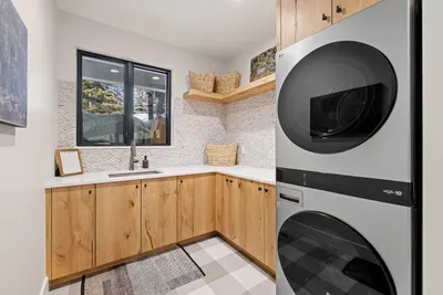 Laundry Made Easy! Featuring two full-sized LG washers and dryers, the laundry room ensures you can handle any load quickly and efficiently. You'll find another set of the same stackables in the daylight basement