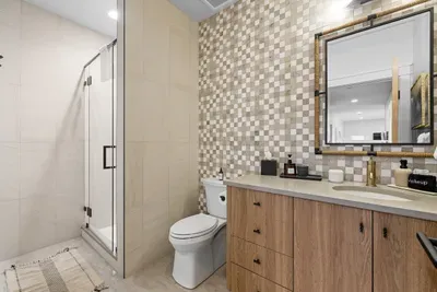 Clean, modern bathrooms with warm finishes and good lighting. Full bathroom on lake level with walk-in shower