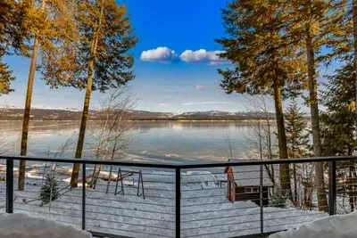 Main‑floor balcony with grill and dining table overlooking Payette Lake