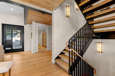 Head upstairs, where you'll find a spacious family room, a desk/workspace, two bunk rooms, and an ensuite bedroom with a queen bed