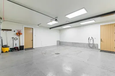 Attached heated garage keeps cars, skis, and bikes out of the elements. Tesla charger included