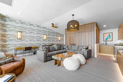 The upstairs family room features a spectacular 75" TV, setting the stage for epic movie nights and game days. With its open layout and comfortable seating, it’s the perfect spot to gather