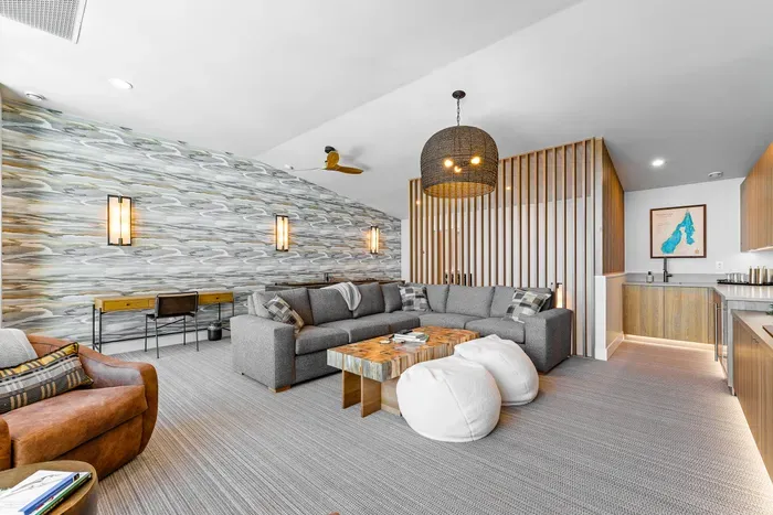 The upstairs family room features a spectacular 75" TV, setting the stage for epic movie nights and game days. With its open layout and comfortable seating, it’s the perfect spot to gather