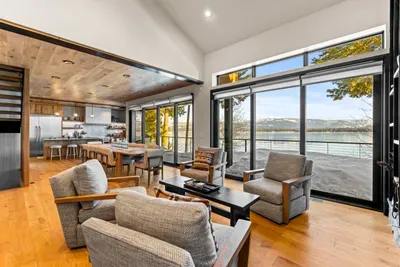 Main‑floor family room with gas fireplace and big lake‑view windows