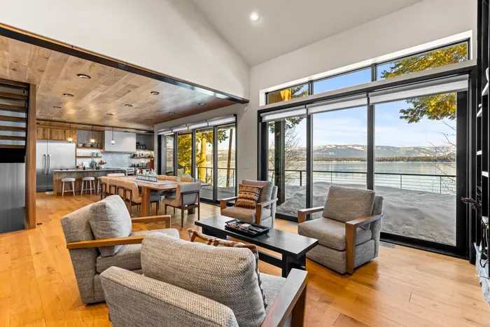 Main‑floor family room with gas fireplace and big lake‑view windows