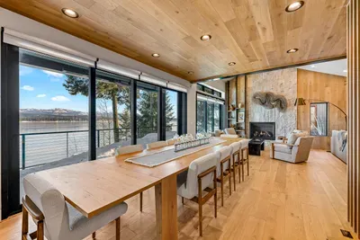 Unpretentious luxury: soft sofas, warm wood, and big water views from every angle.