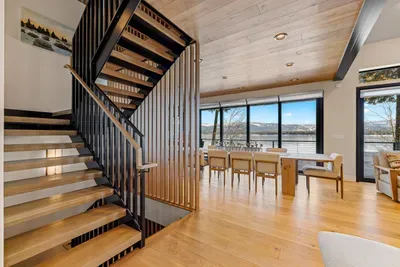 Head downstairs, where you'll find another spacious family room with a wet bar, two king bedrooms, a full bath, a powder room, a second laundry room, and access to the lower patio and lake