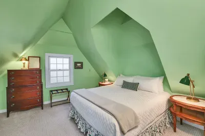 Upstairs king bedroom: Cracked window, cool night air, and the distant sound of water on the shore