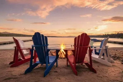 Watch the sun slip behind the mountains and paint the sky right from your beach