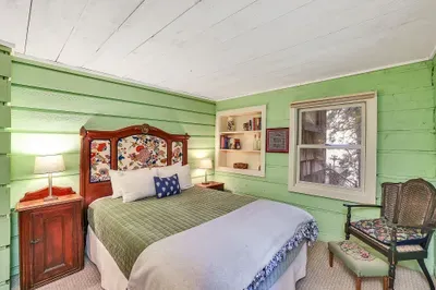 Main‑floor queen bedroom—easy access, no stairs, and classic cabin coziness