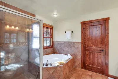 Soothe ski legs and trail miles in the deep soaker tub, then rinse off under the walk‑in shower—your own mini spa just off the bedroom