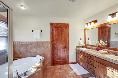 Keep the chill outside—step into warm tile, a generous shower, and a tub that invites you to linger a little longer