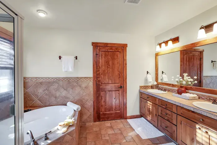 Keep the chill outside—step into warm tile, a generous shower, and a tub that invites you to linger a little longer