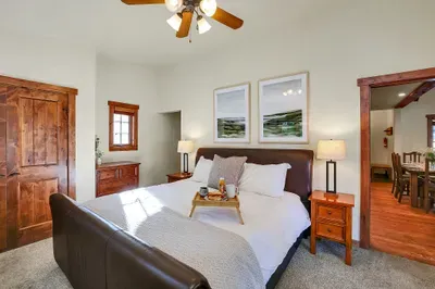 Settle into the main‑floor king suite—no stairs, just soft linens, warm light, and quick access to the heart of the cottage