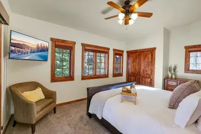 With its own en‑suite bath and king bed, the downstairs suite gives one couple or guest their own private corner of the cottage