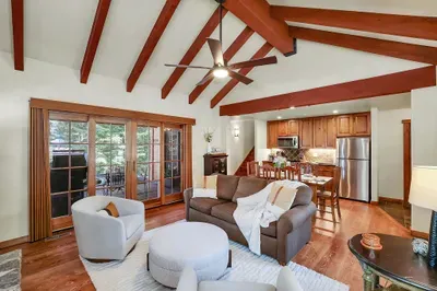 Big windows, warm wood floors, and an open layout create a bright, relaxed gathering space after long days on the mountain or course