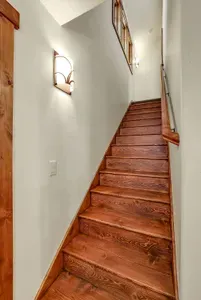 Upstairs, the second suite feels like its own little retreat—tucked away under the eaves with plenty of room to spread out