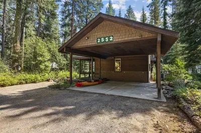 There's room for 2 cars in the covered carport, as well as room for a trailer on the north end of the driveway. The next aerial shot helps illustrate parking