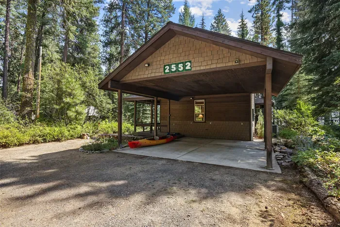 There's room for 2 cars in the covered carport, as well as room for a trailer on the north end of the driveway. The next aerial shot helps illustrate parking