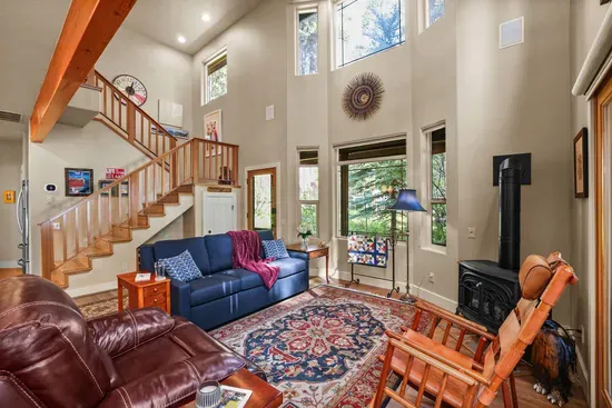 We can't get enough of the natural light! The open concept living area features a queen sofa sleeper, gas fireplace, and patio access