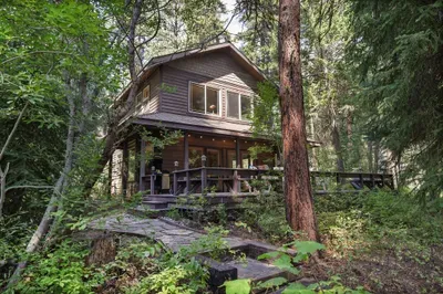 The back deck is peaceful and idyllic, and the trail to the beach is located right next to the property (photo taken from trail)