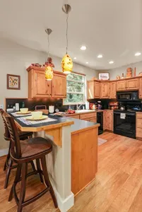 The kitchen is amply supplied for home cooking + baking--pots, pans, bakeware, dishware, glassware, drip coffee maker, crockpot--it's all here! Appliances include electric stovetop/oven, microwave, stainless French door fridge, + dishwasher