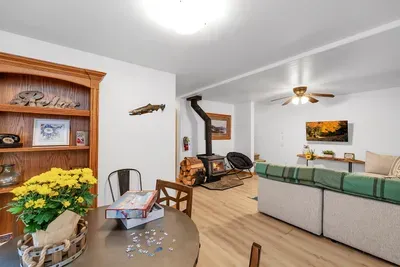 The downstairs family room is your go-to spot for movie nights and board games, featuring comfy seating and a welcoming vibe