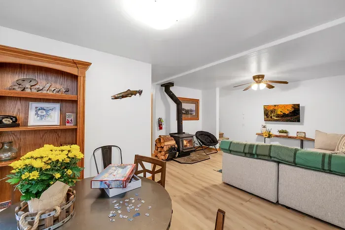 The downstairs family room is your go-to spot for movie nights and board games, featuring comfy seating and a welcoming vibe