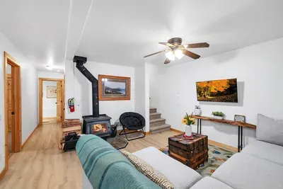 Gather around the wood stove in the downstairs family room, where a large comfy sectional invites you to relax and enjoy cozy evenings in