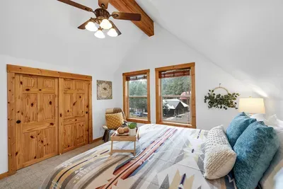 Bright, airy upstairs king bedroom with a quiet, tucked-in-the-trees feel.