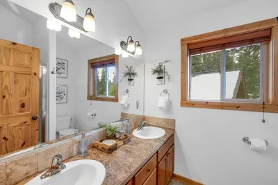 Dual-vanity upstairs bath makes shared mornings easy for couples or families.