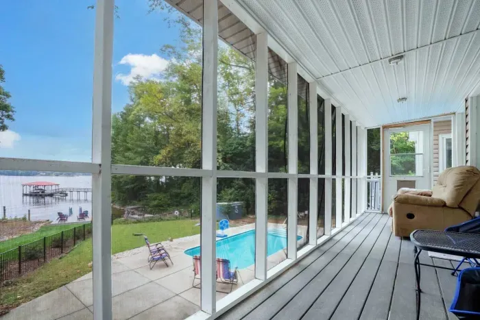Screened in porch overlooking the lake, perfect for enjoying a cup of coffee or glass of wine.