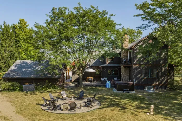 A serene backyard haven with a circular firepit lounge.