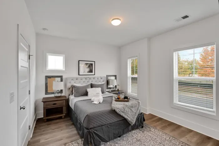 Bright and stylish bedroom with a comfy queen bed, elegant decor, and plenty of natural light