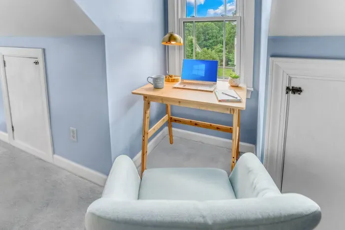 Workspace with a wooden desk and comfortable seat.