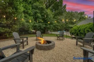 Cozy backyard fire pit with string lights and private wooded ambiance