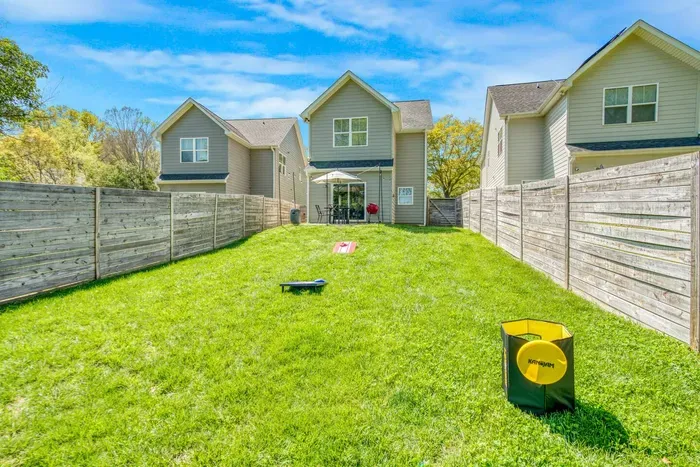 Designed for both play and leisure — enjoy friendly yard games or unwind on the shaded patio surrounded by lush greenery