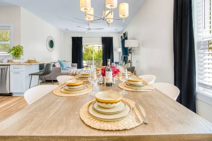 A modern table setting, warm wood tones, and abundant natural light that creates a welcoming space for every meal