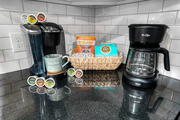Start your mornings right with a fully stocked coffee station featuring both a Keurig and drip coffee maker, plus a selection of coffee pods and essentials for your perfect cup