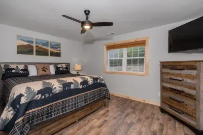 Wake up inspired — this second-floor guest suite is decorated in calming green and black tones, featuring a cozy king bed, 50" Roku Smart TV, and custom Grandfather Mountain wall art. ️