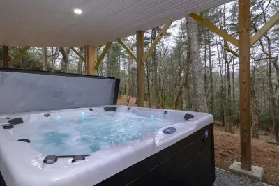 Soak your cares away in our private outdoor hot tub surrounded by peaceful woods — the ultimate mountain retreat. ✨