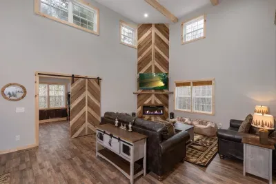 Relax, Gather, Play!  Breathtaking floor-to-ceiling woodwork surrounds the fireplace, with a custom barnwood sliding door leading into the ultimate game room.