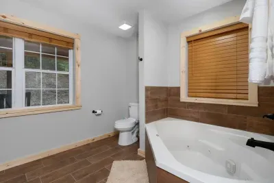 Indulge in a luxurious soak!  Our jetted tub and serene, nature-toned tile create the perfect spa-like sanctuary.