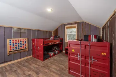 With bold red cargo bunk beds and a giant Connect 4 on the wall, this 3rd level space was made for giggles, games, and great memories!