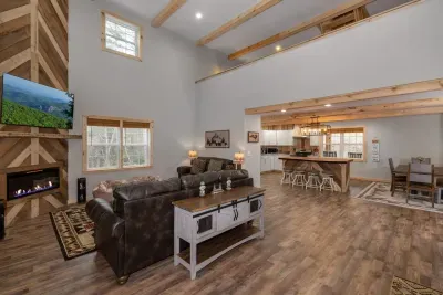 Soaring vaulted ceilings with rustic wood beams and an open layout make this the perfect gathering space in the heart of the mountains.
